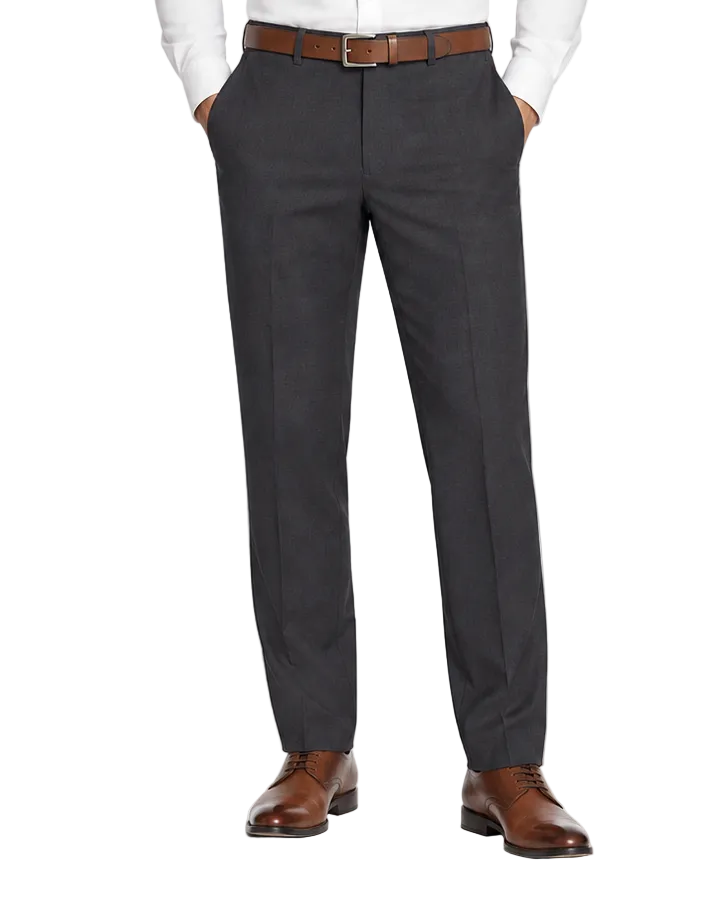 A man modeling a white long-sleeve dress shirt and dark charcoal gray dress pants with a brown belt and brown leather dress shoes, photographed against a seamless white studio background.