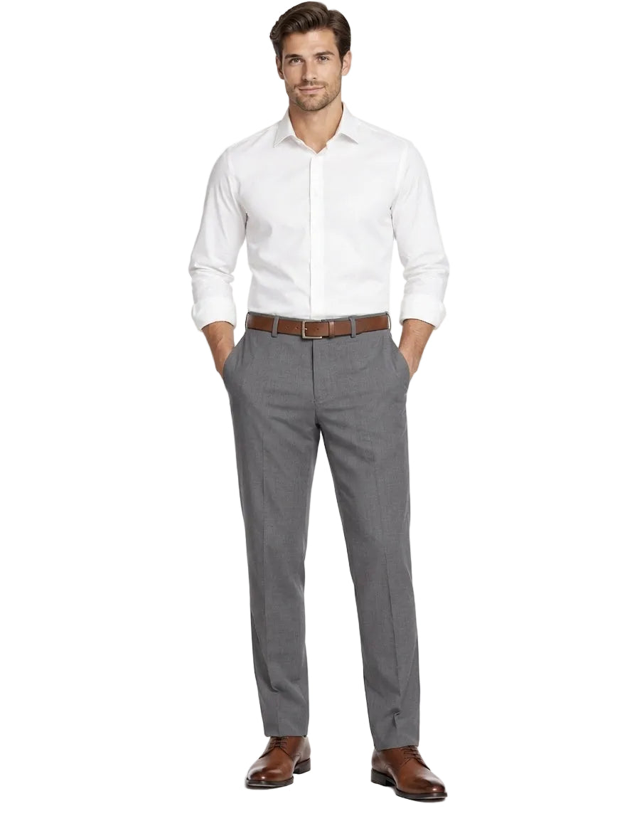 A man modeling a white long-sleeve dress shirt and gray dress pants with a brown belt and brown leather dress shoes, standing against a plain white studio background.
