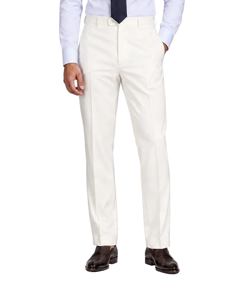 A man modeling a light blue dress shirt, dark navy tie, off-white trousers, and dark brown dress shoes against a neutral gray studio background.