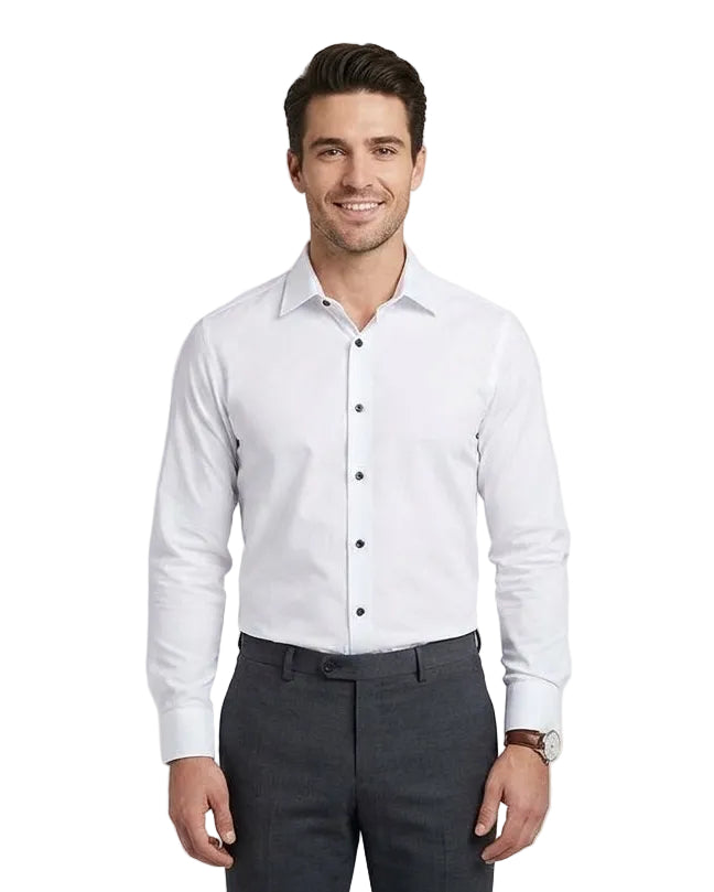 A man wearing a white long-sleeve button-down dress shirt and dark gray trousers, standing against a light gray studio background.