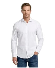 Load image into Gallery viewer, A man wearing a white long-sleeve button-down dress shirt and blue jeans, standing against a plain white studio background.