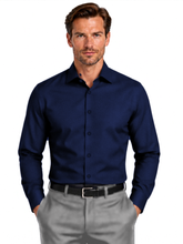 Load image into Gallery viewer, A man wearing a dark navy blue long-sleeve button-down shirt and light gray dress pants, standing against a plain white background.