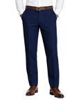 A man modeling a white long-sleeve dress shirt and navy blue dress pants with a brown belt and brown leather dress shoes, standing against a plain white studio background.