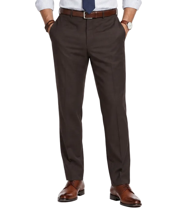 A man modeling a light blue dress shirt, navy tie, dark brown trousers, a brown belt, and brown leather dress shoes against a plain white studio background.